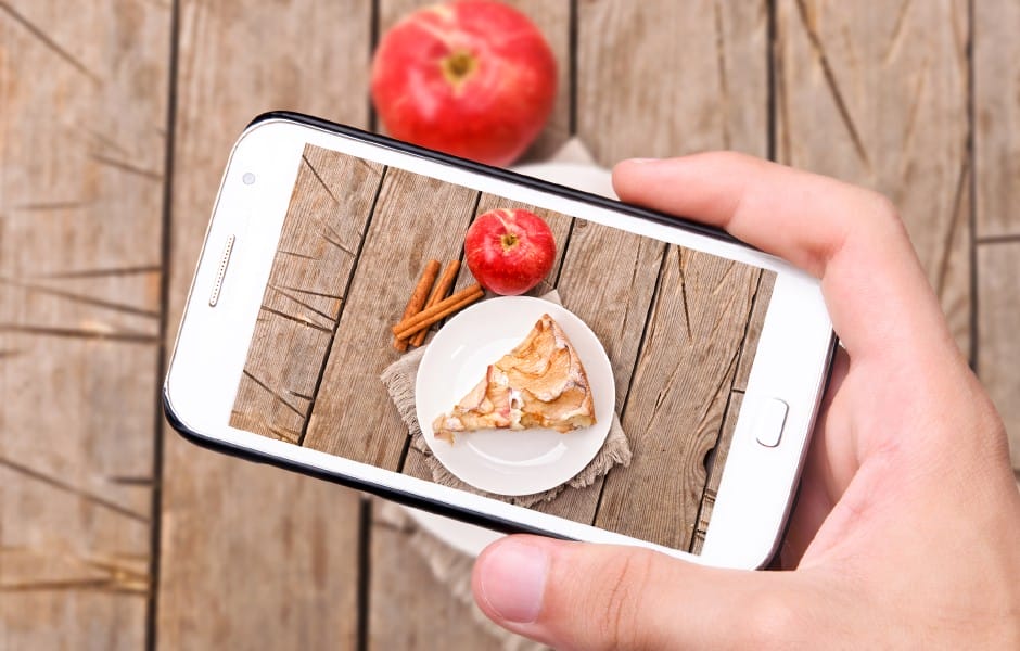 UGC Hands taking photo apple cake with smartphone
