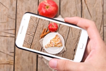 UGC Hands taking photo apple cake with smartphone
