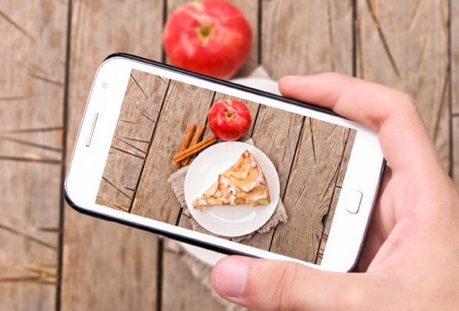 UGC Hands taking photo apple cake with smartphone