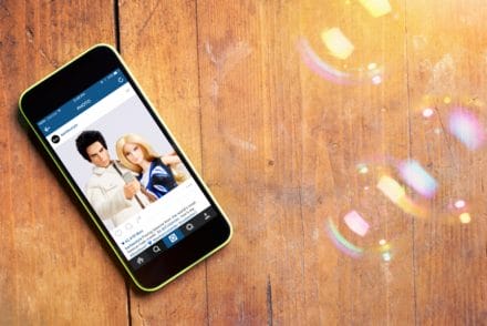 Wooden background with iPhone barbie zoolander Instagram