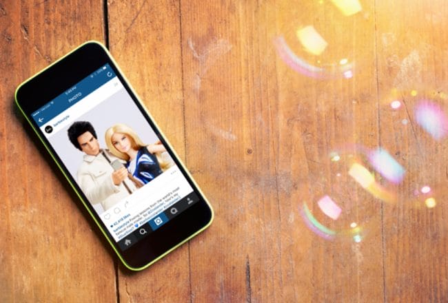 Wooden background with iPhone barbie zoolander Instagram