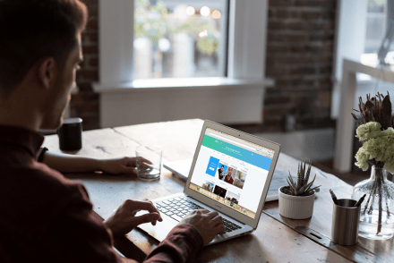 male using twitter on laptop