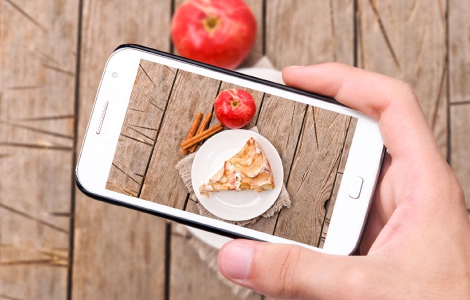 UGC hands taking photo apple cake with smartphone.png