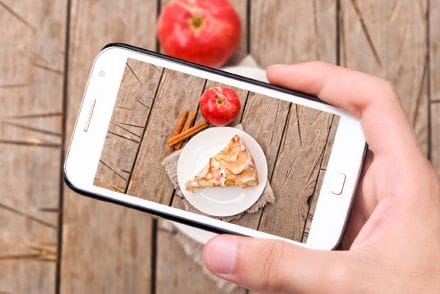 UGC hands taking photo apple cake with smartphone.png